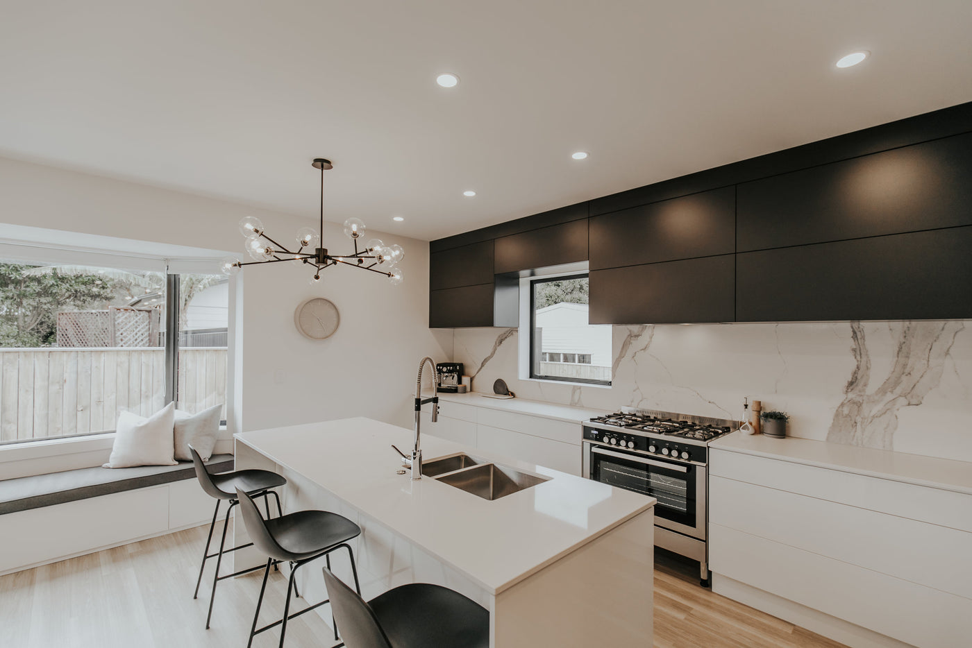 TA Counter Stool with black base by TOOU Design, featuring a sculpted polypropylene seat with a full backrest for stylish counter-height seating.